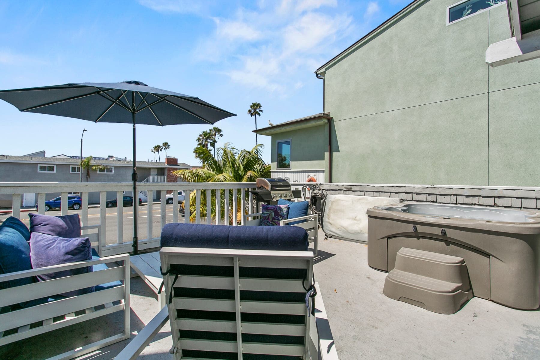 Outdoor deck with umbrella and lounge seating