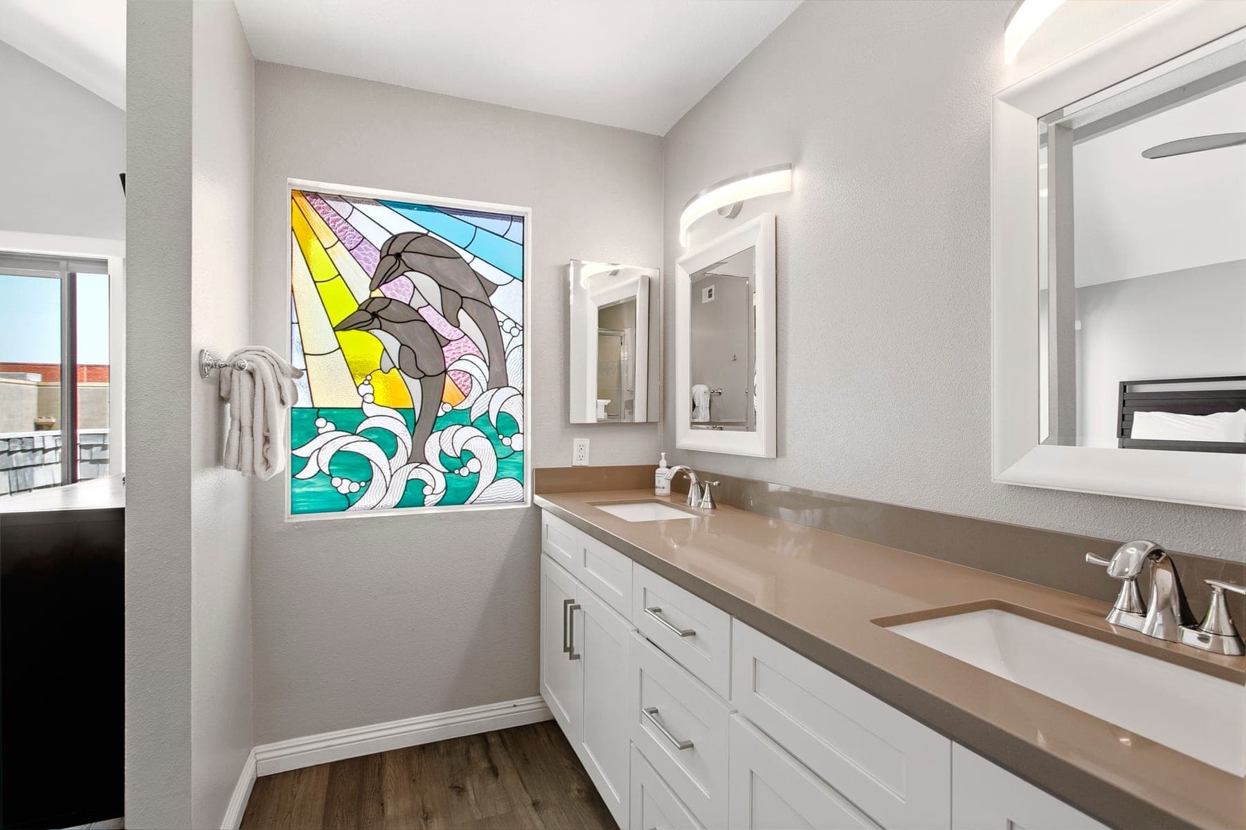 Bathroom vanity with coastal dolphin artwork