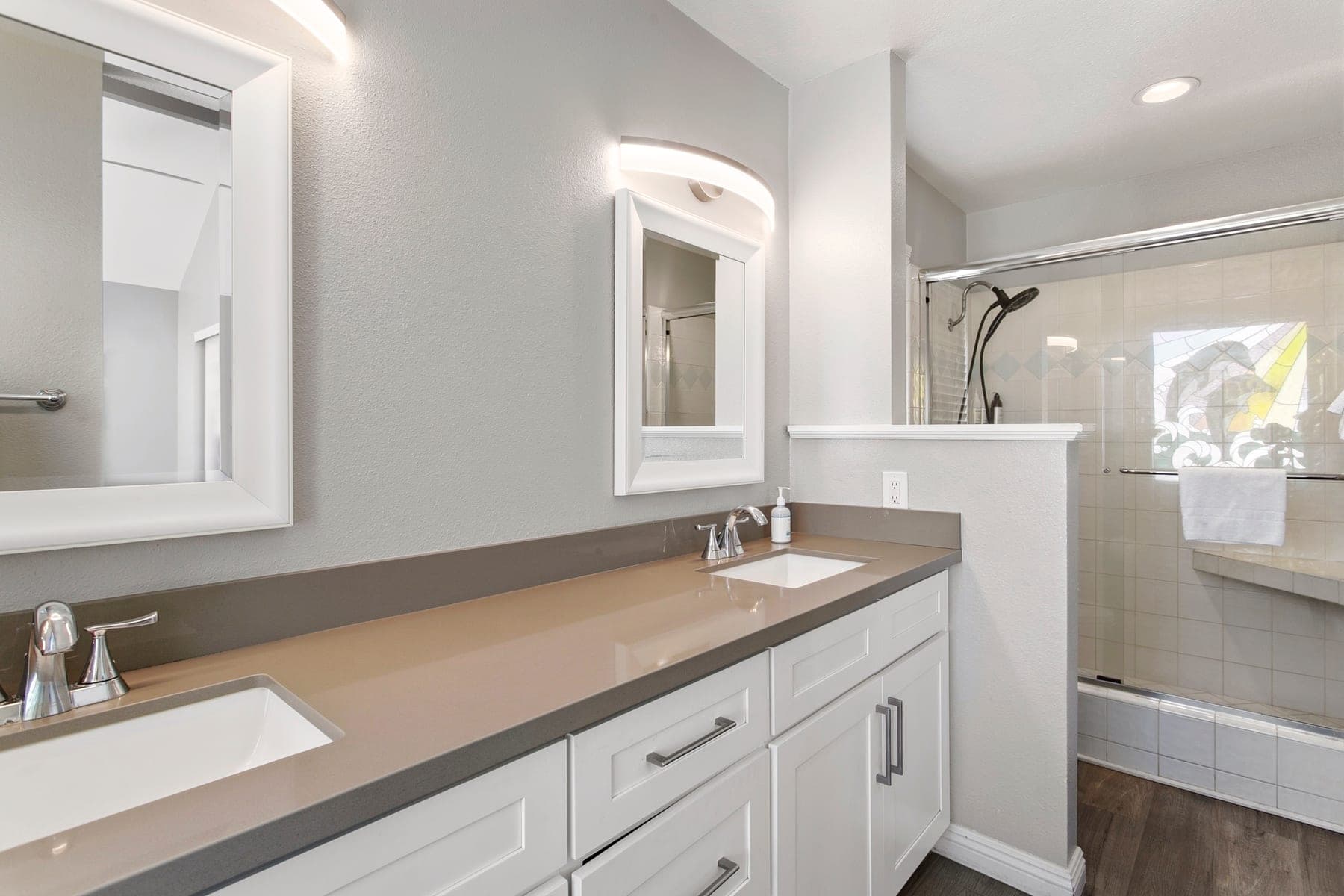 Bathroom vanity and glass shower with fresh towels