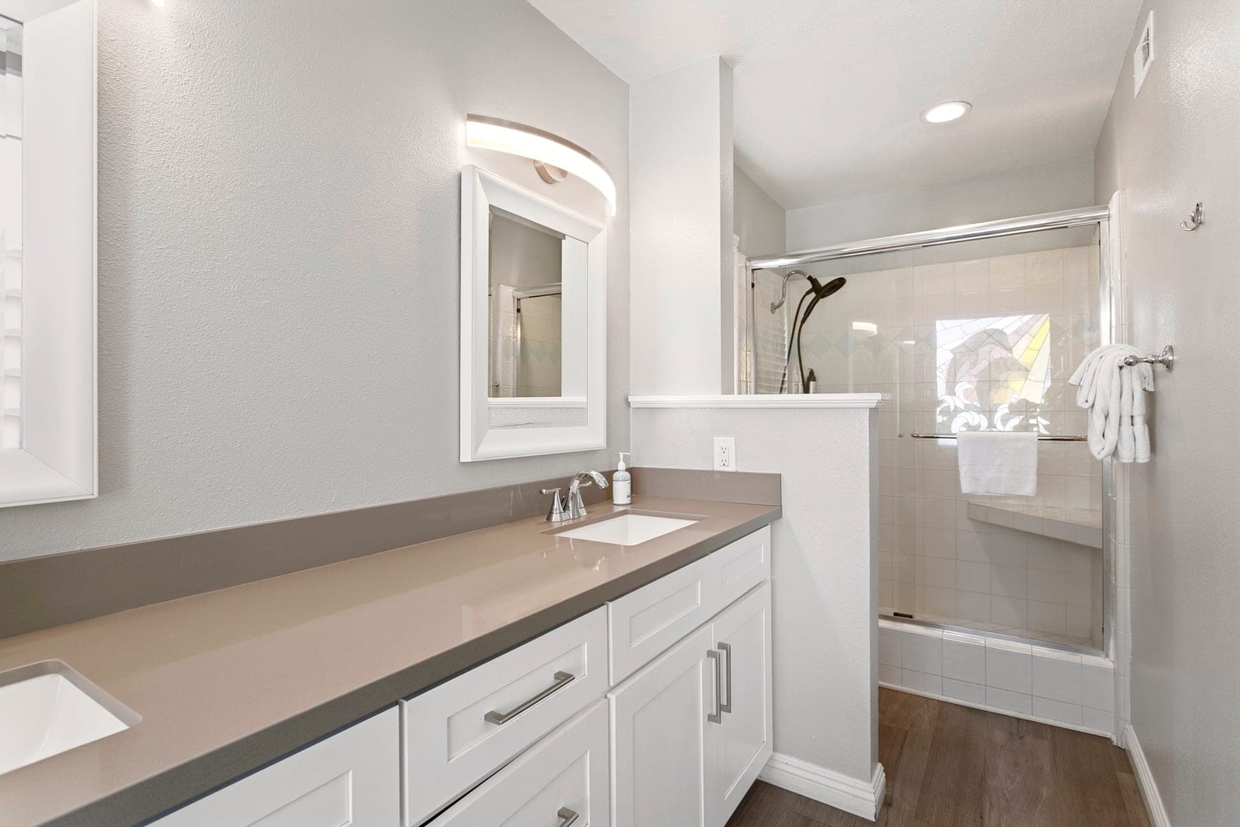 Bathroom vanity with glass shower visible