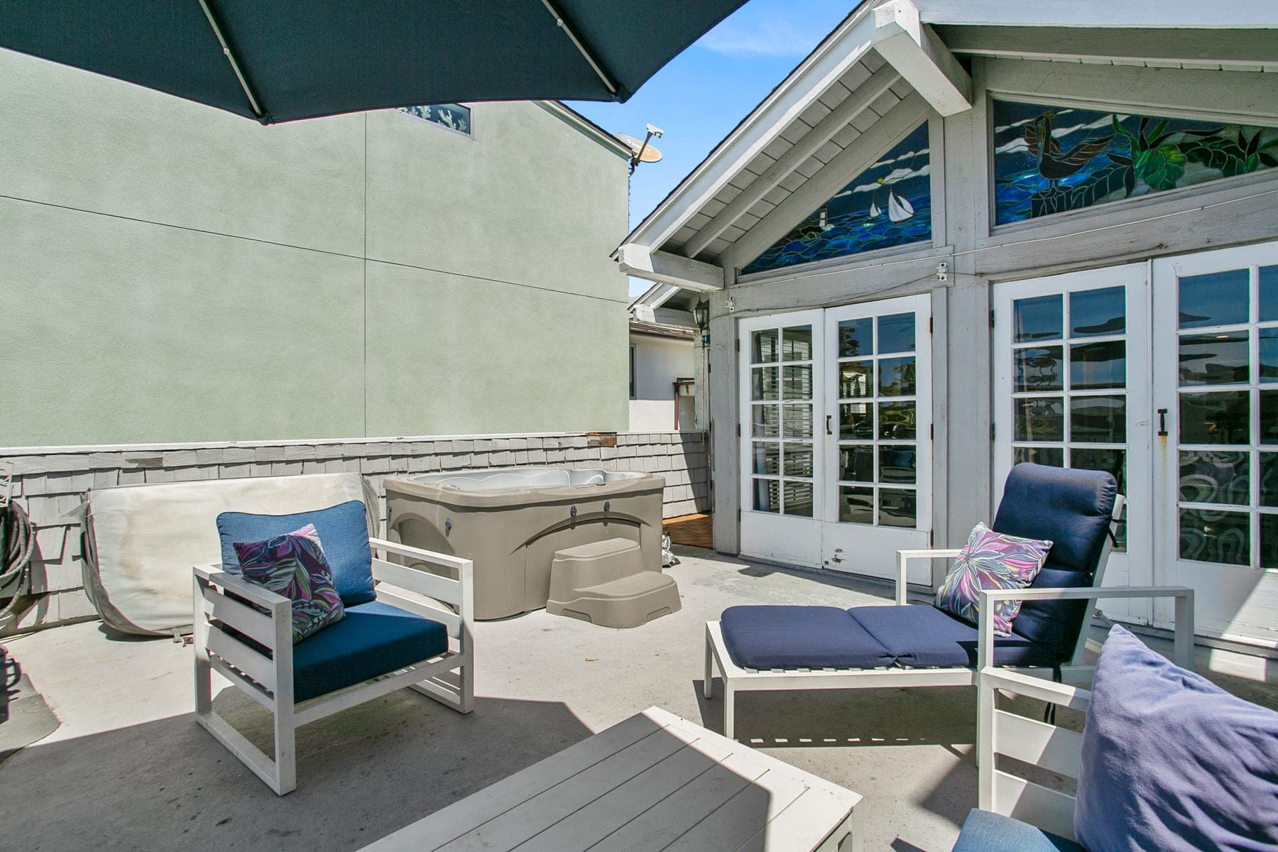 Outdoor lounge seating and grill on the deck