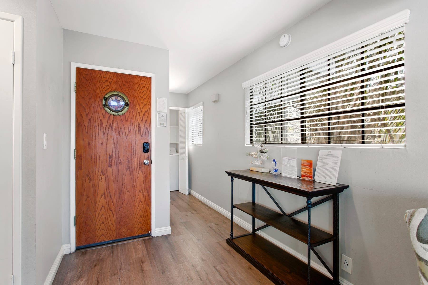 Entry hall with front door, window, and console table