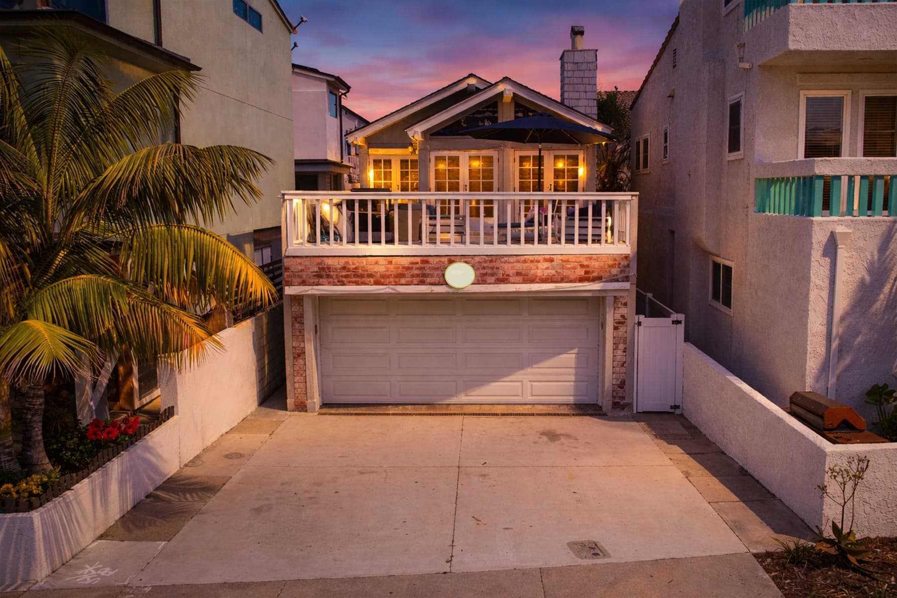 Twilight front exterior of Newport Beach Retreat with balcony lights