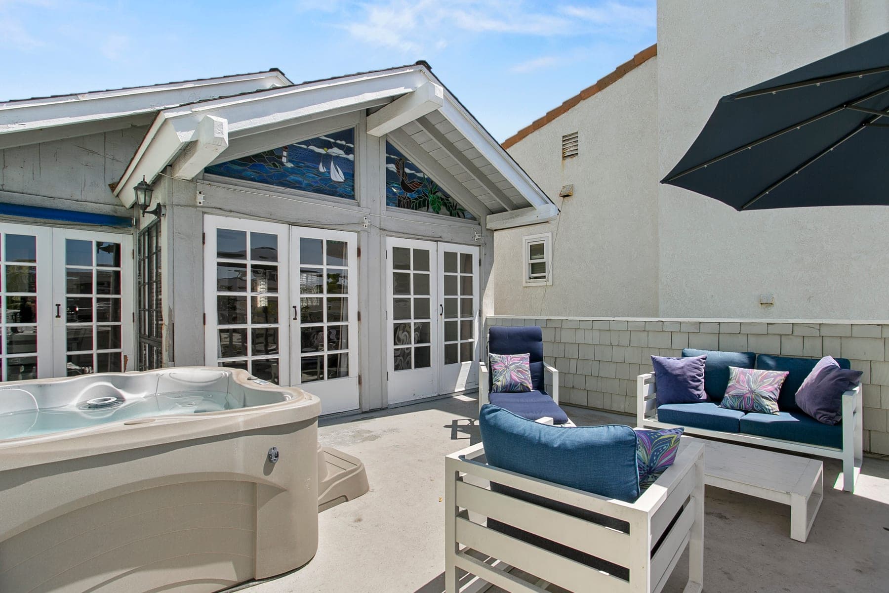 Hot tub and lounge seating on the private outdoor deck