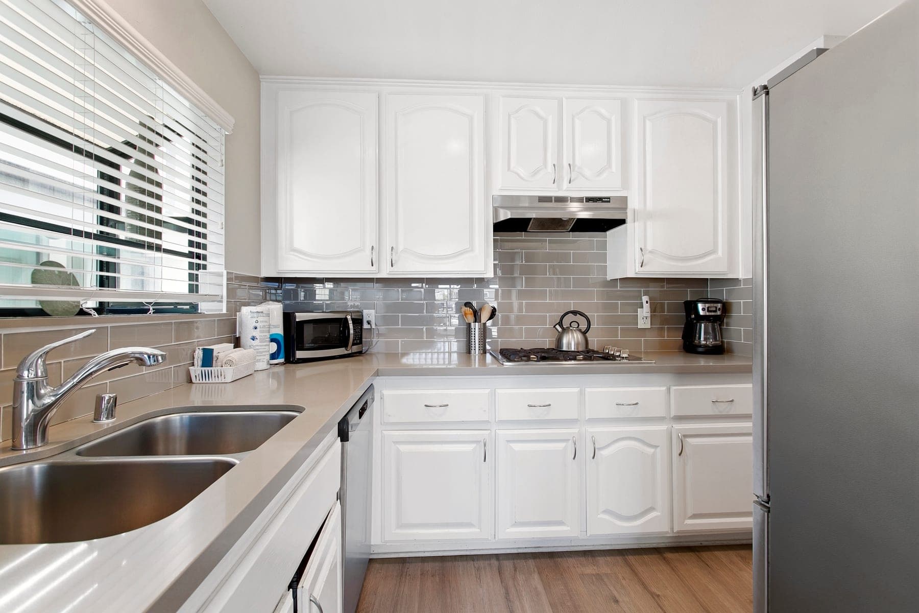 White Newport Beach kitchen with sink, counter space, and small appliances