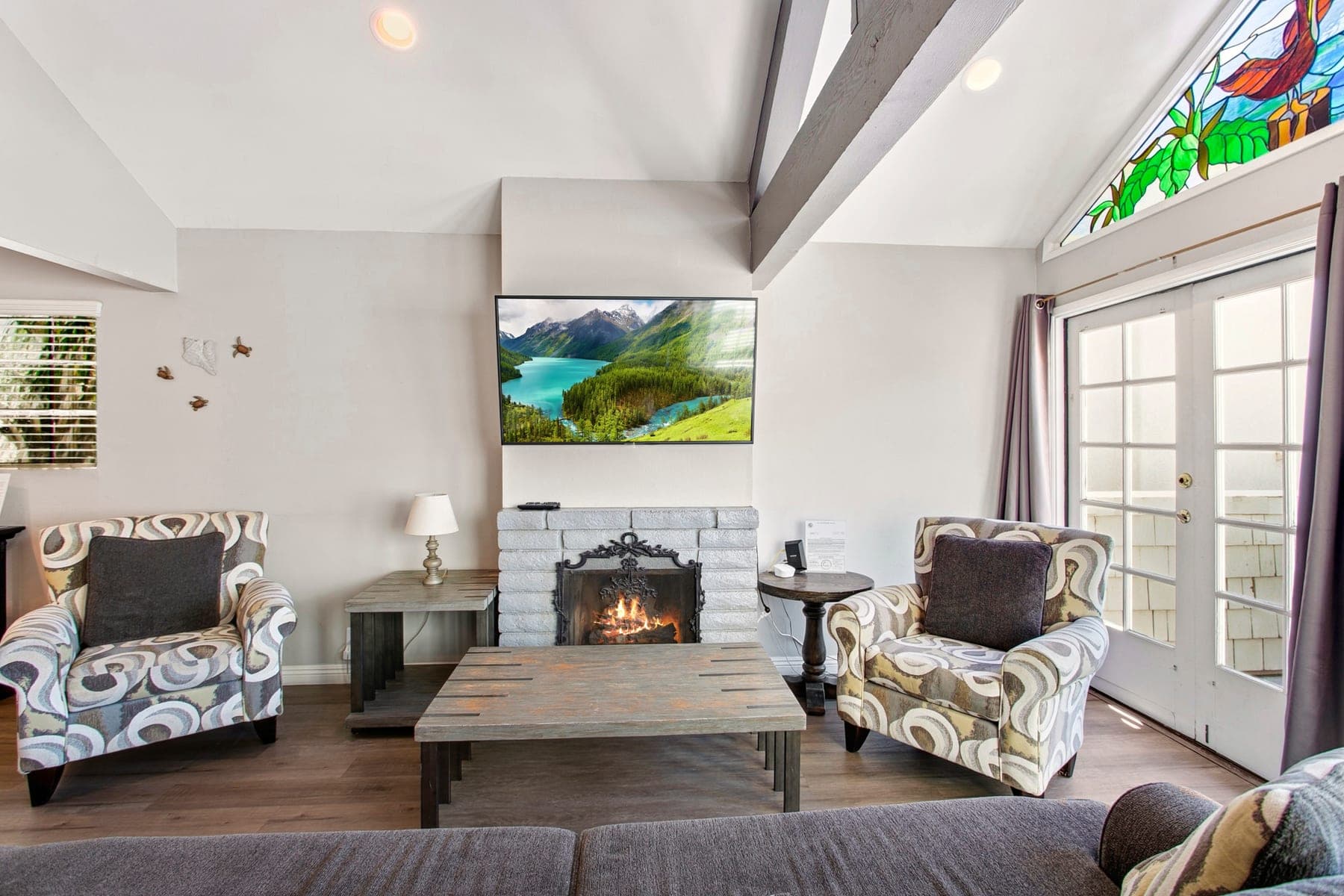 Newport Beach living room with fireplace, Smart TV, and vaulted ceilings